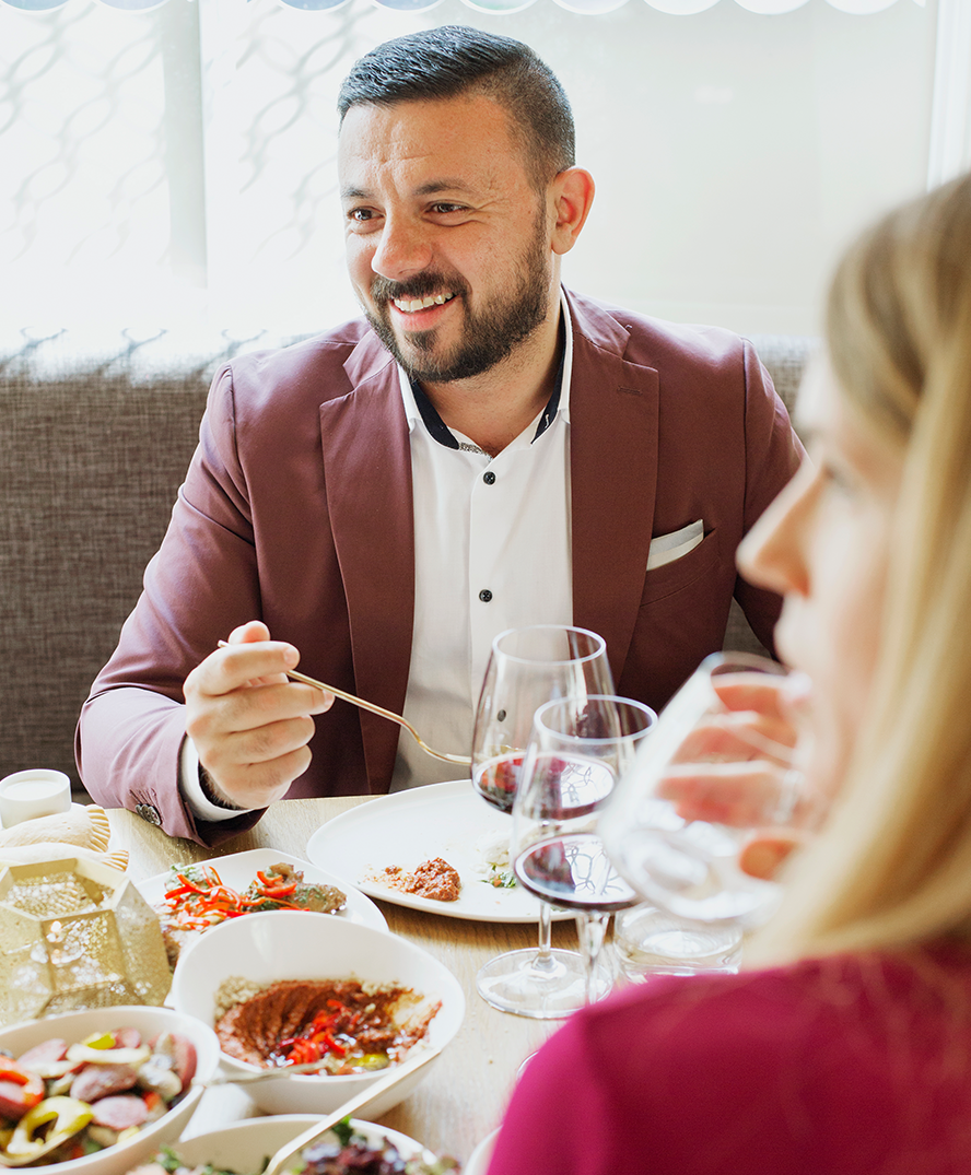 A man laughs when enjoying his meal.